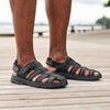 Close-up of man's legs wearing the Men's Hudson orthopedic sandals in Black