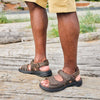 Quarter side view of man's legs while wearing the Propet Men's sandals outside
