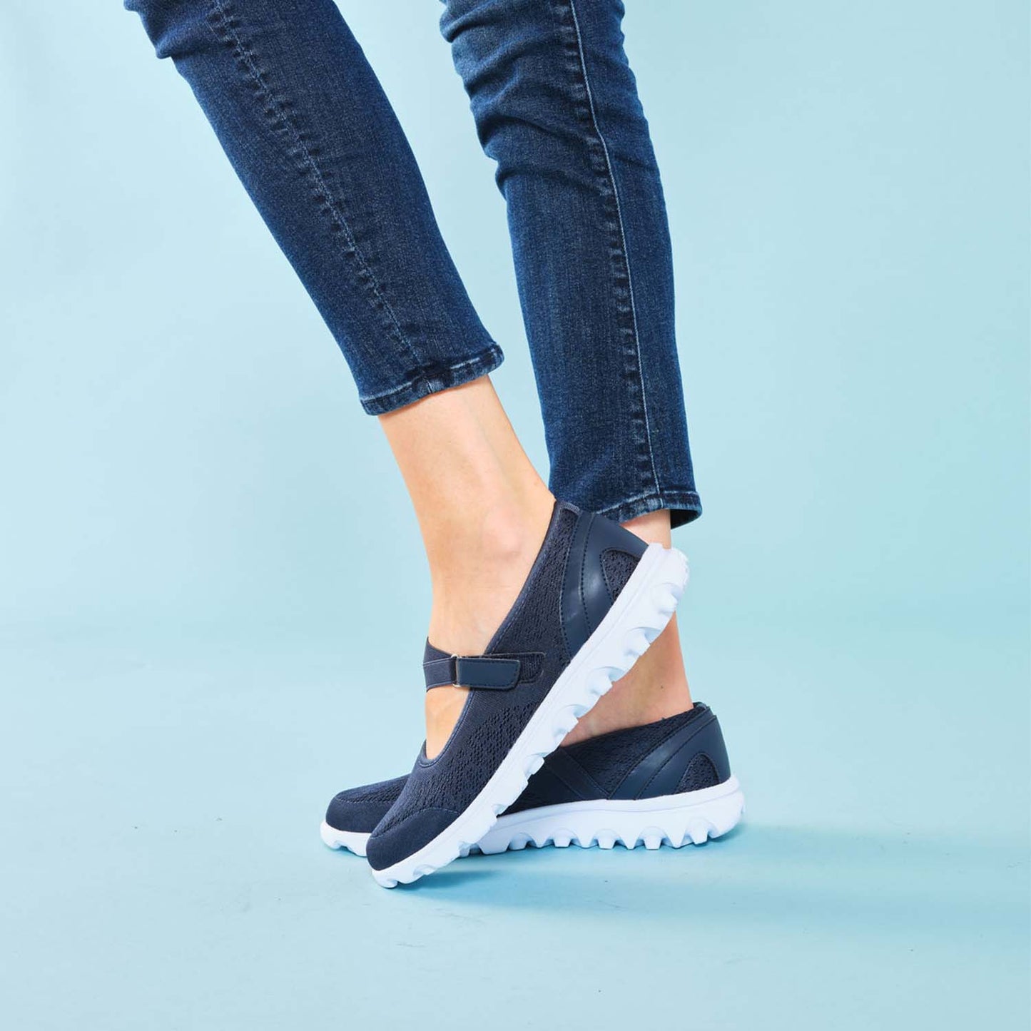 Side view of woman wearing the TravelActiv™ Women's Mary Jane against a light blue studio backdrop