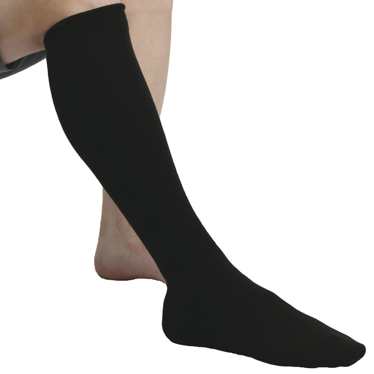 Black knee-high sock on a person's leg against a white background