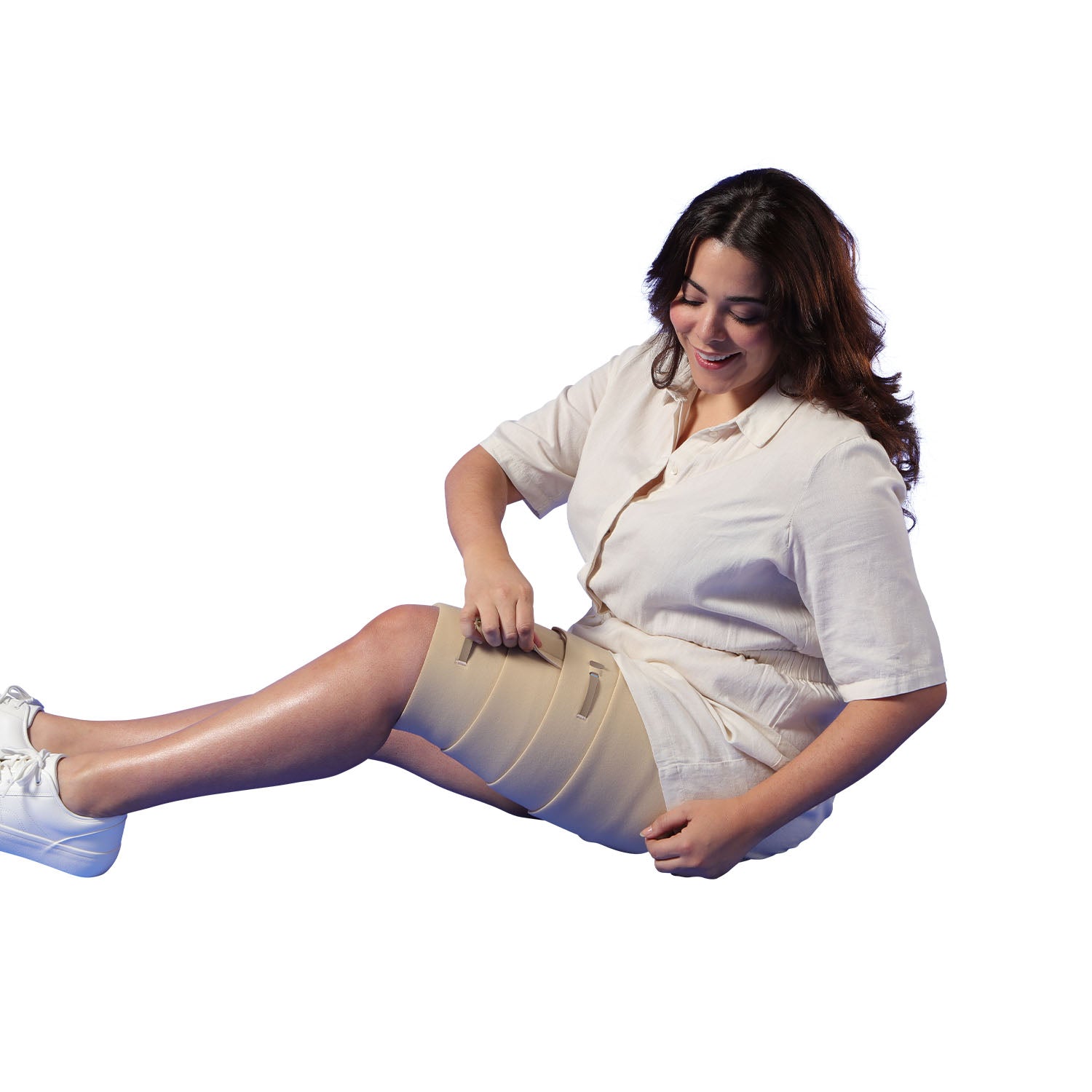 Woman wearing a compression garment on her leg with a white background