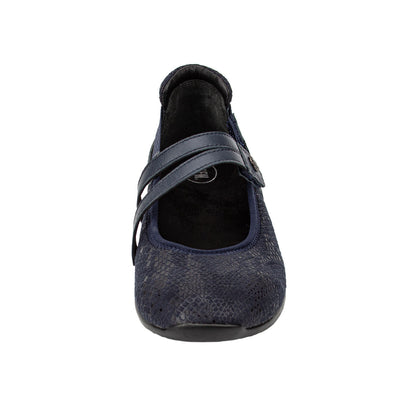 Navy blue flat shoe with a strap on a white background