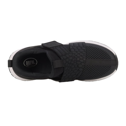 Black athletic shoe with a strap on a white background
