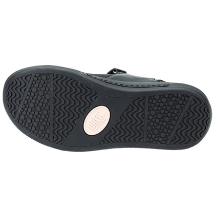 The black rubber outsole of a shoe, featuring a wavy tread pattern and a circular beige brand patch in the center, shown against a plain white background.
