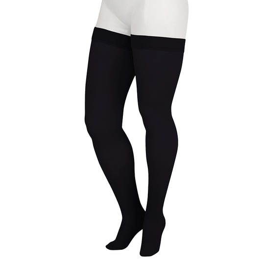 Juzo 2001 Soft Thigh Highs 20-30 mmHg - Black thigh-high stockings worn by a model, shown from the waist down against a plain white background.