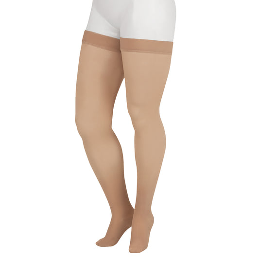 Juzo 2001 Soft Thigh Highs 20-30 mmHg - A pair of sheer beige thigh-high stockings worn on a model's legs, shown against a plain white background.