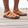 Close-up of man's legs wearing the Men's Hudson orthopedic sandals in Tan