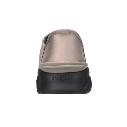 A single shoe shown from the back, featuring a metallic taupe upper and a thick black sole with the brand name 'Propet' embossed on it, set against a plain white background.