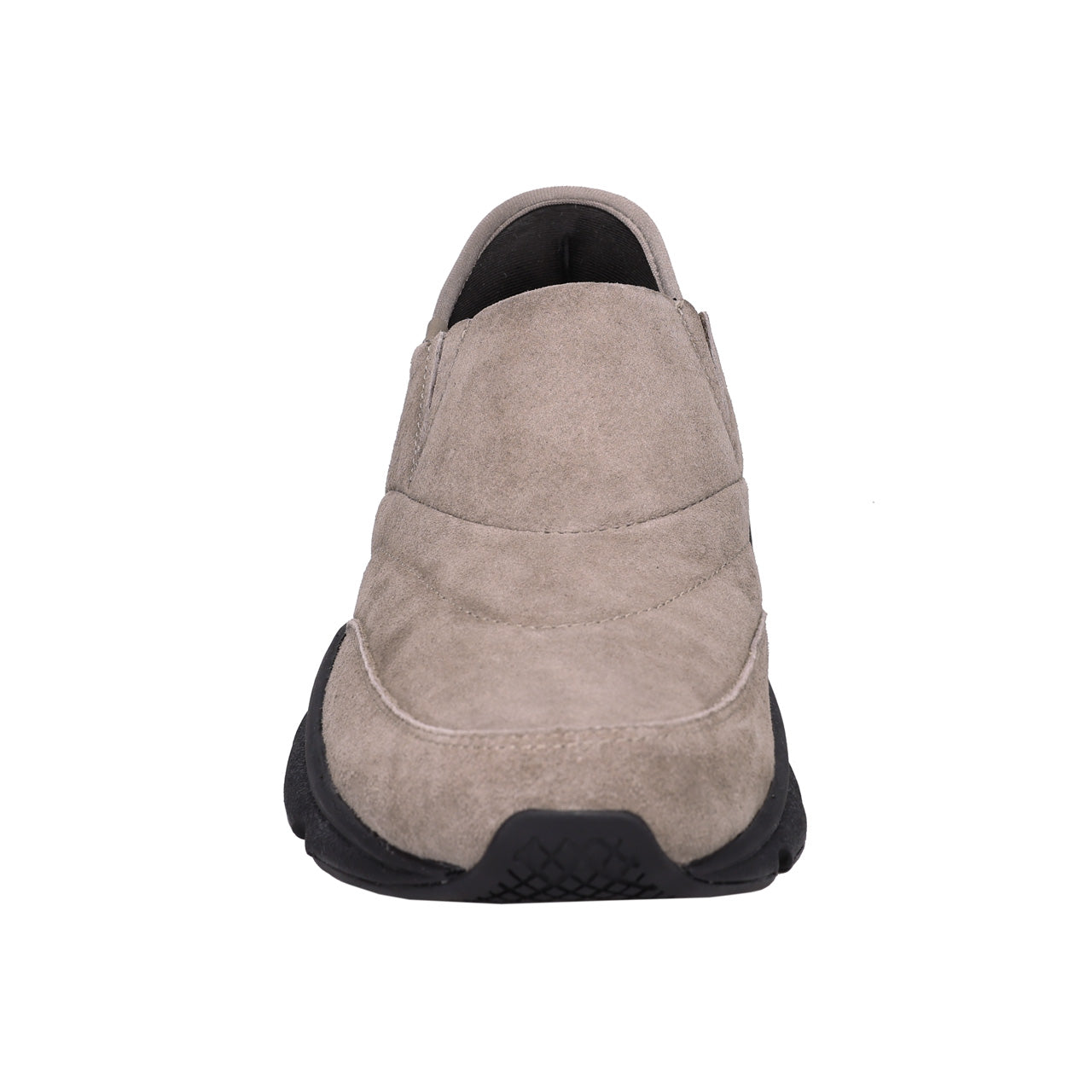 A single slip-on shoe shown from the back, featuring a taupe suede upper and a chunky black sole, set against a plain white background.