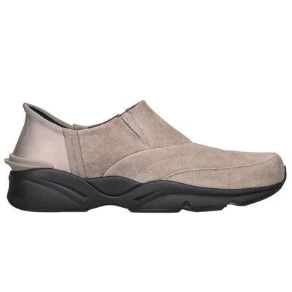 A single slip-on wedge shoe in taupe suede with a chunky black sole, shown from a side profile view against a plain white background.