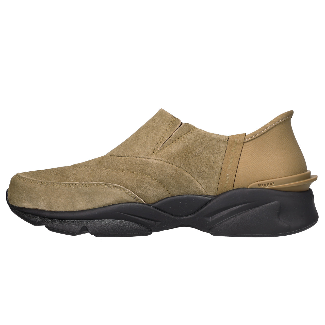 A slip-on casual shoe in tan suede and beige leather with a chunky black sole, shown from a side profile on a white background.