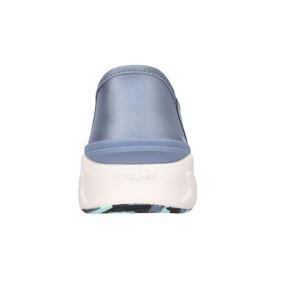 A single slip-on clog shoe shown from the back, featuring a dusty blue satin upper and a thick white sole with the brand name 'Propét' embossed on the side.