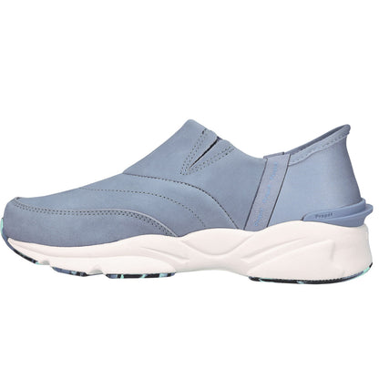 A light blue slip-on sneaker with a thick white and blue textured sole, shown from a side profile view on a white background.