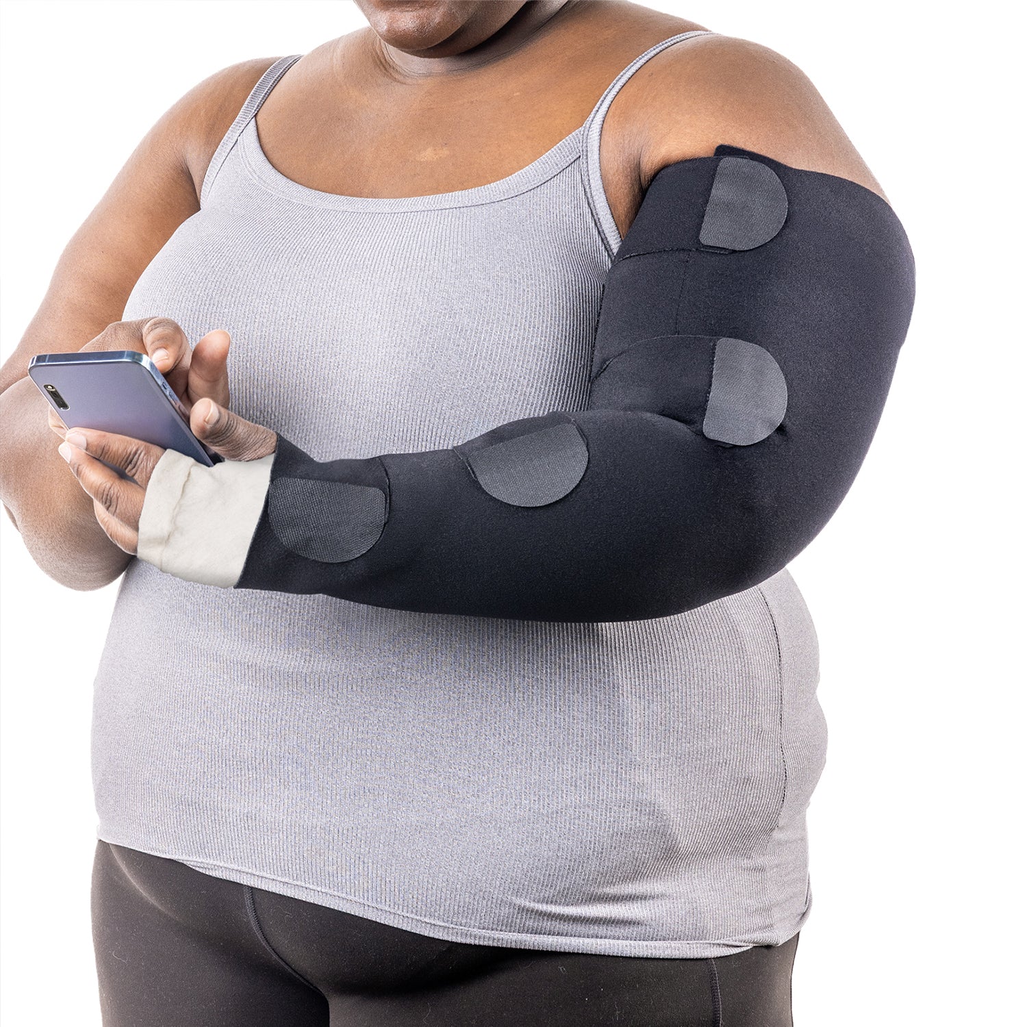 A person wearing a Sigvaris Envelo Compressive Inelastic Arm Wrap while holding a smartphone.