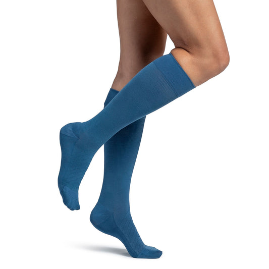 Sigvaris 262 Style Bamboo Knee High 20-30mmHg - Blue knee-high socks worn by a person on a white background