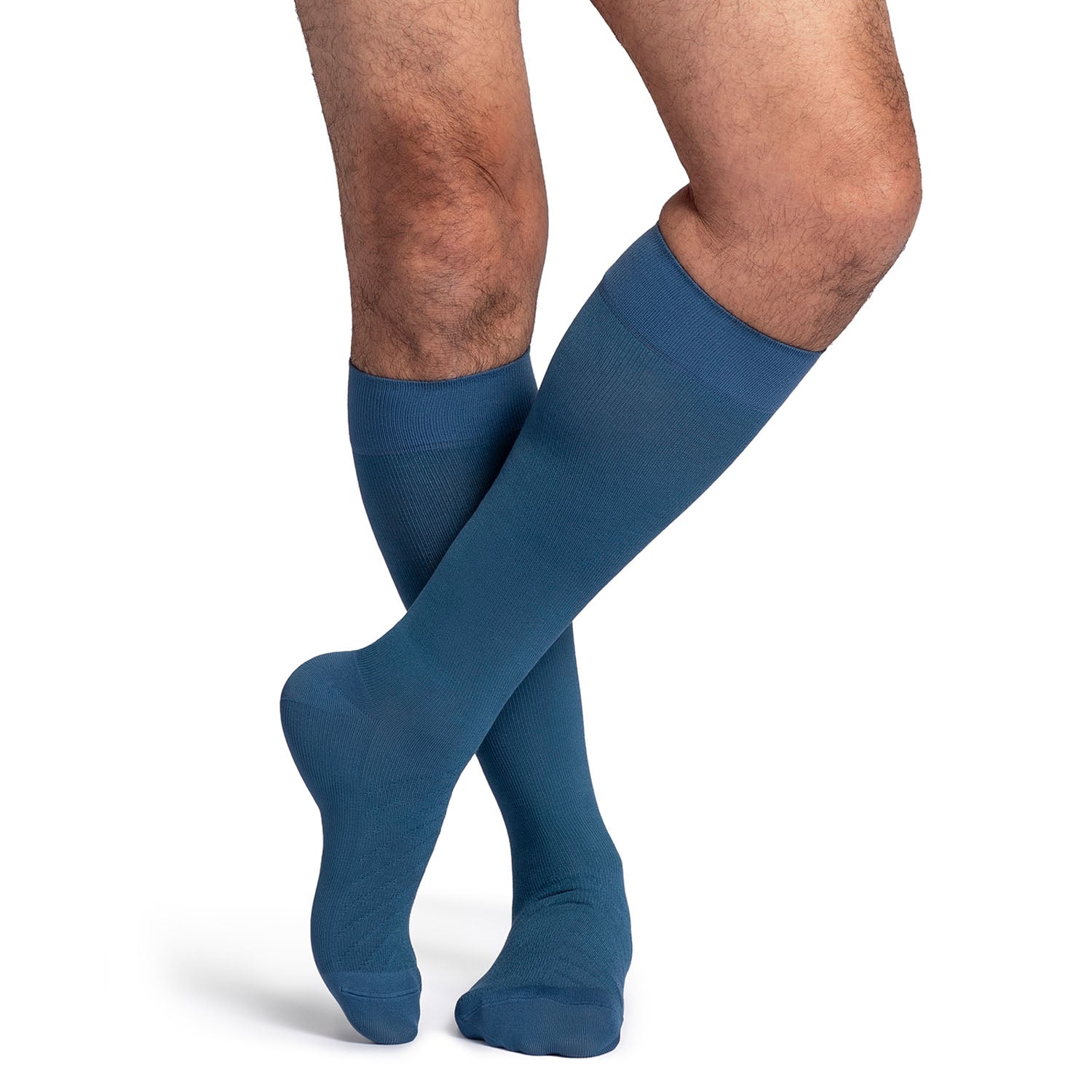 Blue knee-high socks worn by a person on a white background