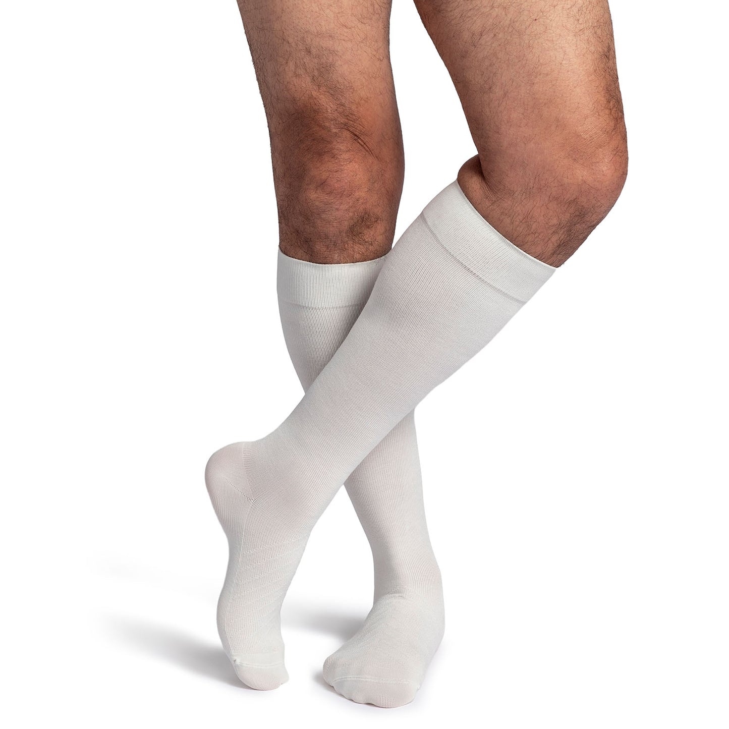 White knee-high socks worn by a person on a white background