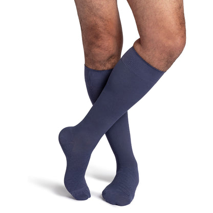 Navy blue knee-high socks worn by a person on a white background