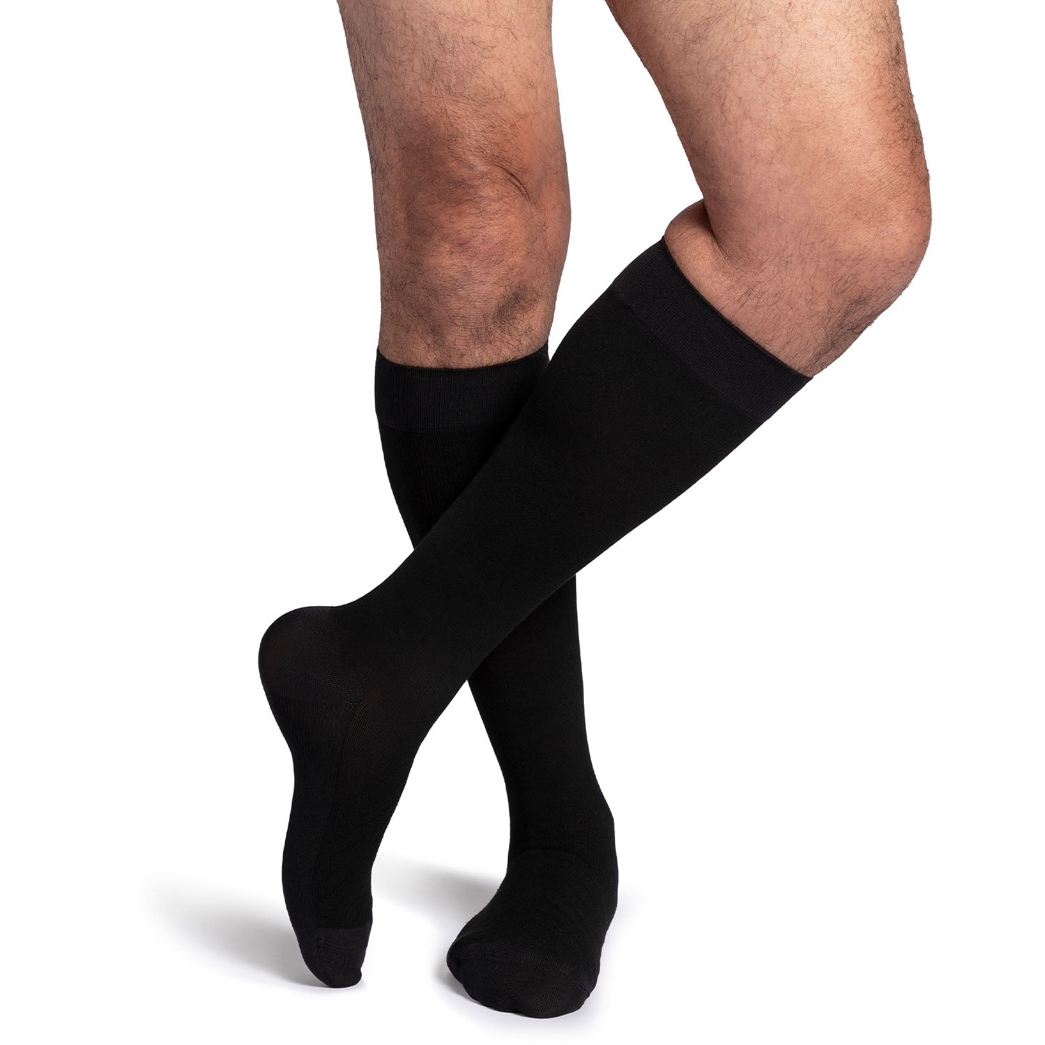 Black knee-high socks worn by a person on a white background