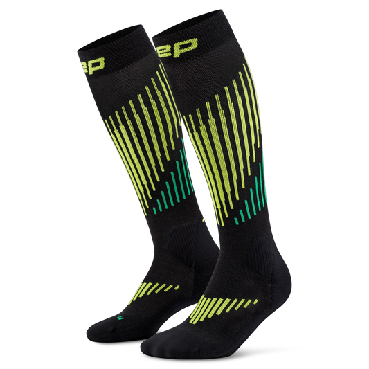 CEP Men's Ski Touring Merino Tall Socks - A pair of black knee-high athletic socks with a vibrant lime green and teal striped pattern, featuring the brand logo 'BP' on the cuff.