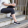 Woman sitting on stairs outside while wearing the TravelActiv Mary Jane in Black 